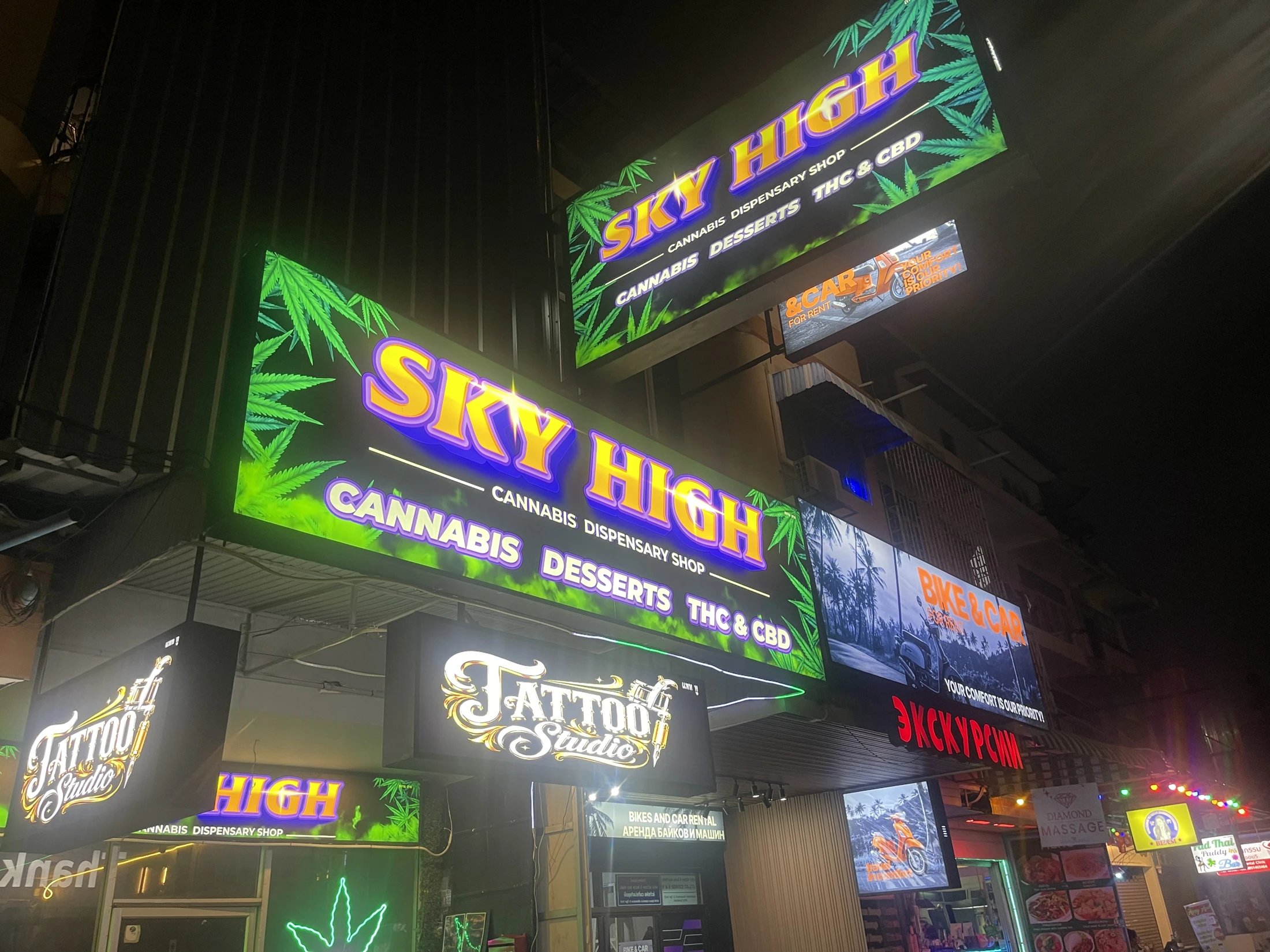 The original illuminated Sky High signs at night